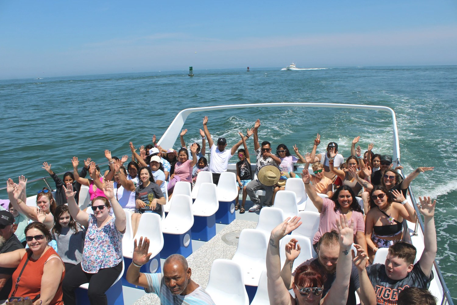 a group of people posing in front of a large body of water