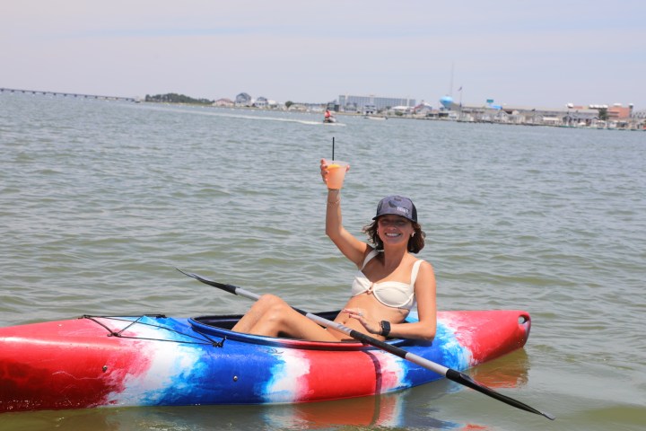a person riding on the back of a boat in the water