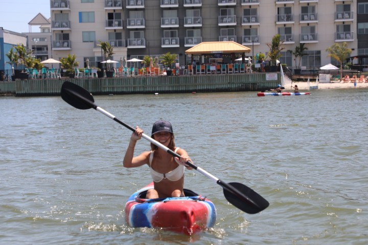 a person riding on the back of a boat in a body of water