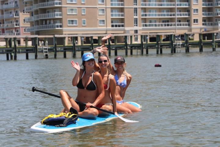 a group of people rowing a boat in the water