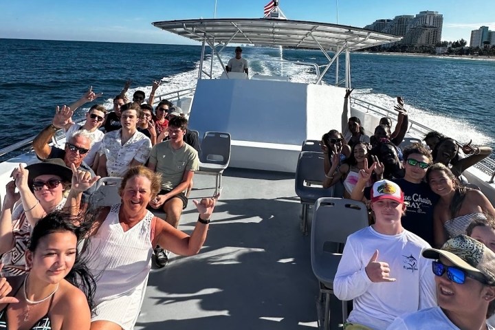 a group of people in a boat on a body of water