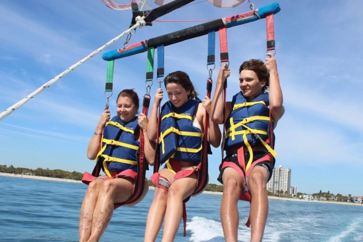 a man riding on the back of a boat in a body of water