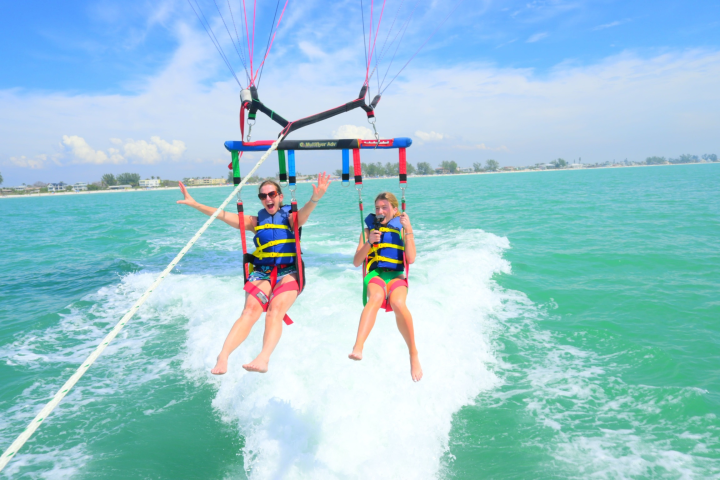 a girl riding a wave on top of a body of water