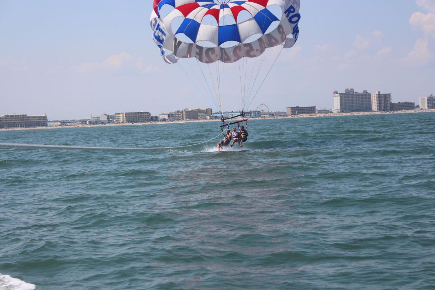 a person flying a kite in a large body of water