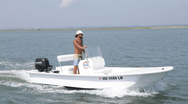 a man riding on the back of a boat in a body of water