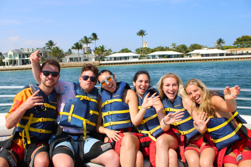 Group of people smiling aboard the Sea Rocket Parasail Boat.