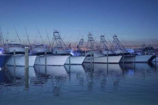 a boat is docked next to a body of water