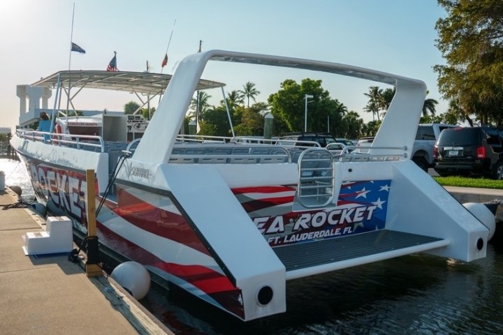 Boat named Sea Rocket docked at a marina with American flag colors on stern.