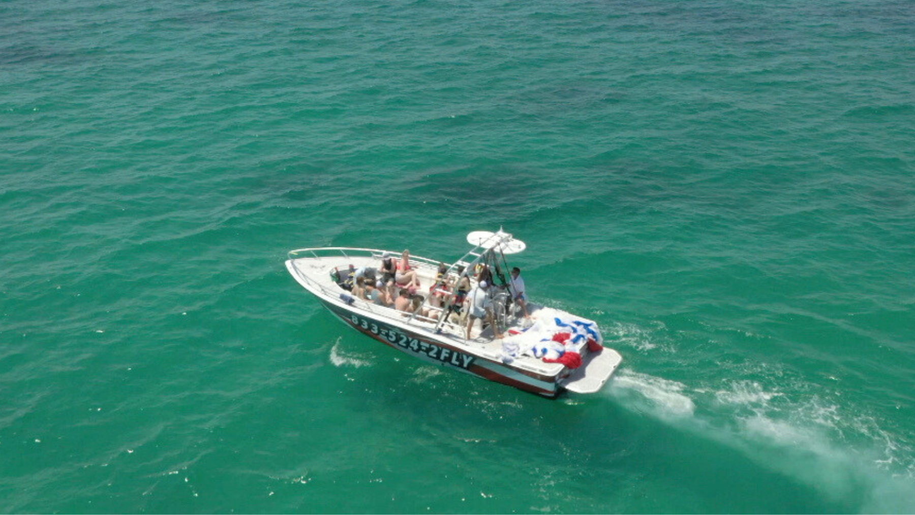 A Sea Rocket private tour boat cruising through the bright emerald waters near Bradenton Beach on the Gulf Coast.