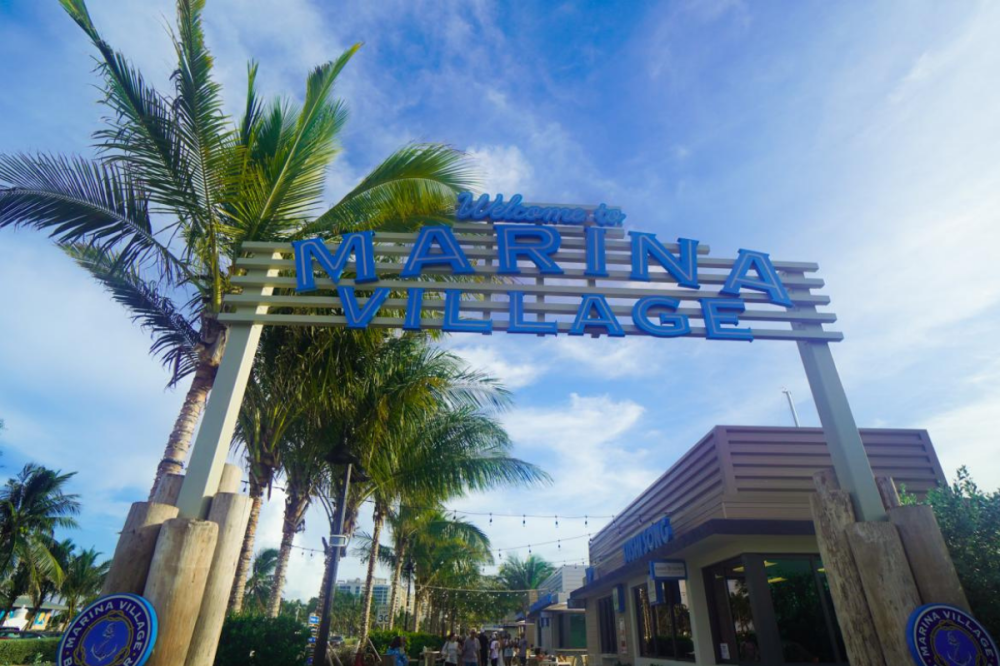 A sign that says “Marina Village” in an entry way for food vendors in Fort Lauderdale 
