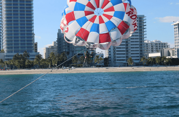 Two people parasailing over the ocean in Fort Lauderdale