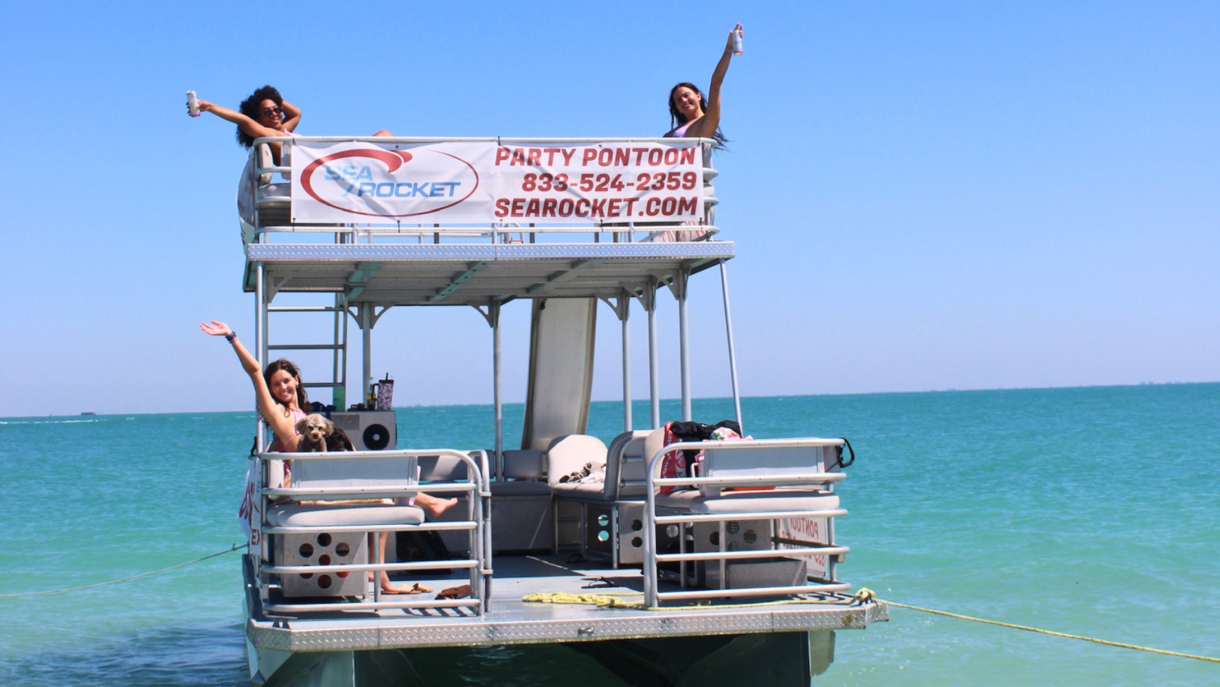Two-story party pontoon boat with upper sundeck and water slide on the Gulf of Mexico near Bradenton Beach