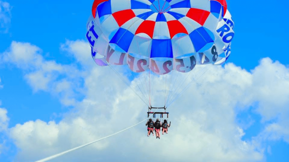 Parasailing over Anna Maria Island with turquoise Gulf waters and white sand beaches below