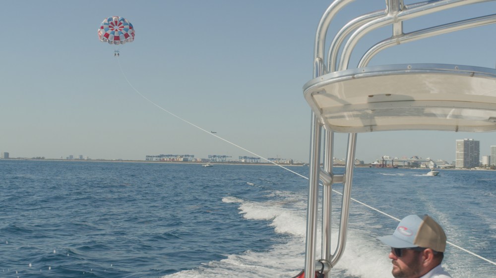 Two people parasailing with Fort Lauderdale Beach views